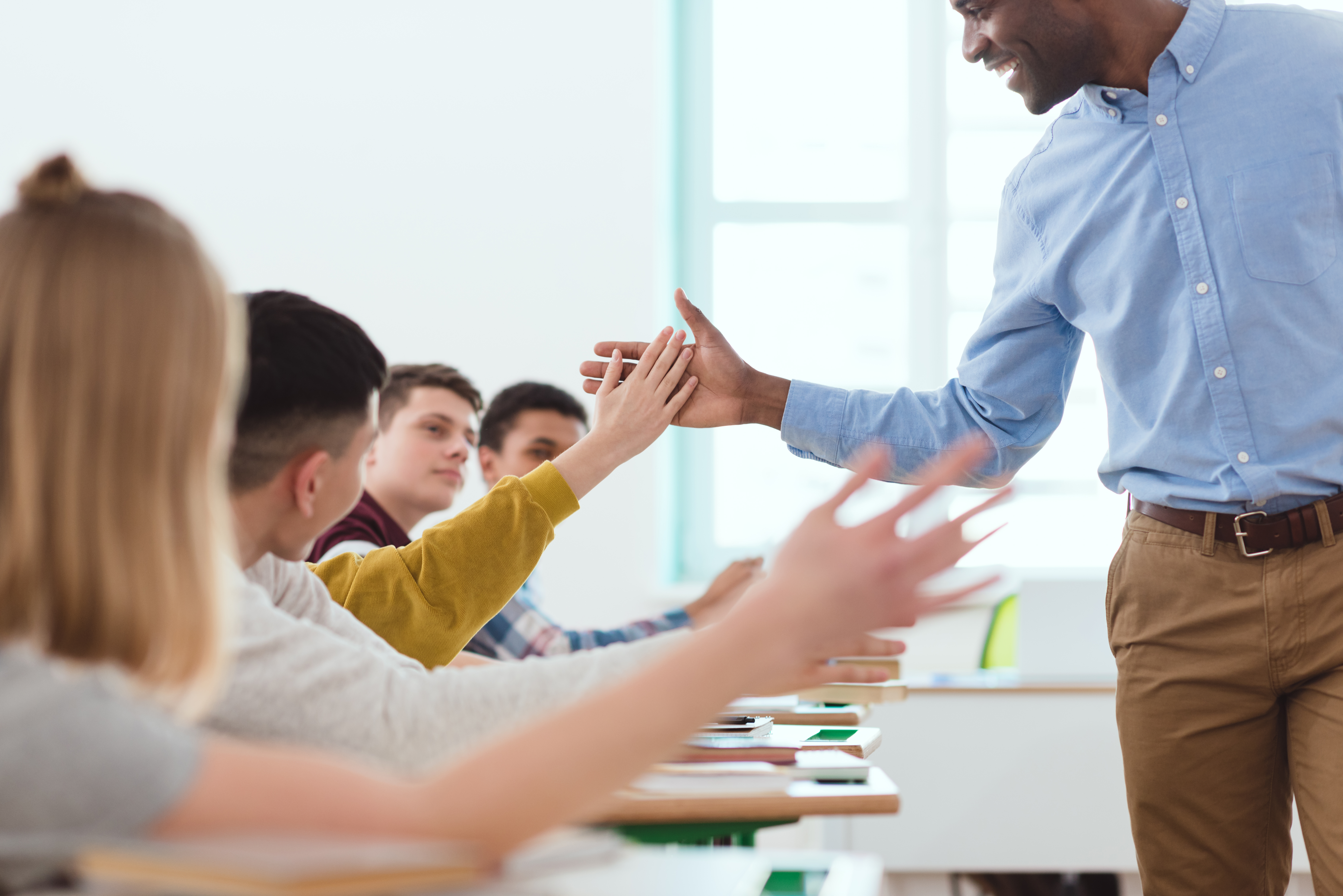 teacher giving teachers a high five