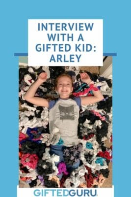 girl on bed of stuffed toys with title interview with a gifted kid