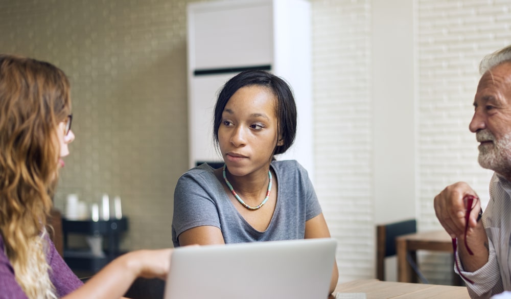 three people in a meeting